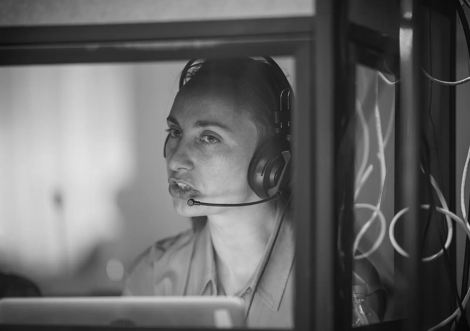 An interpreter working in a booth with a headset